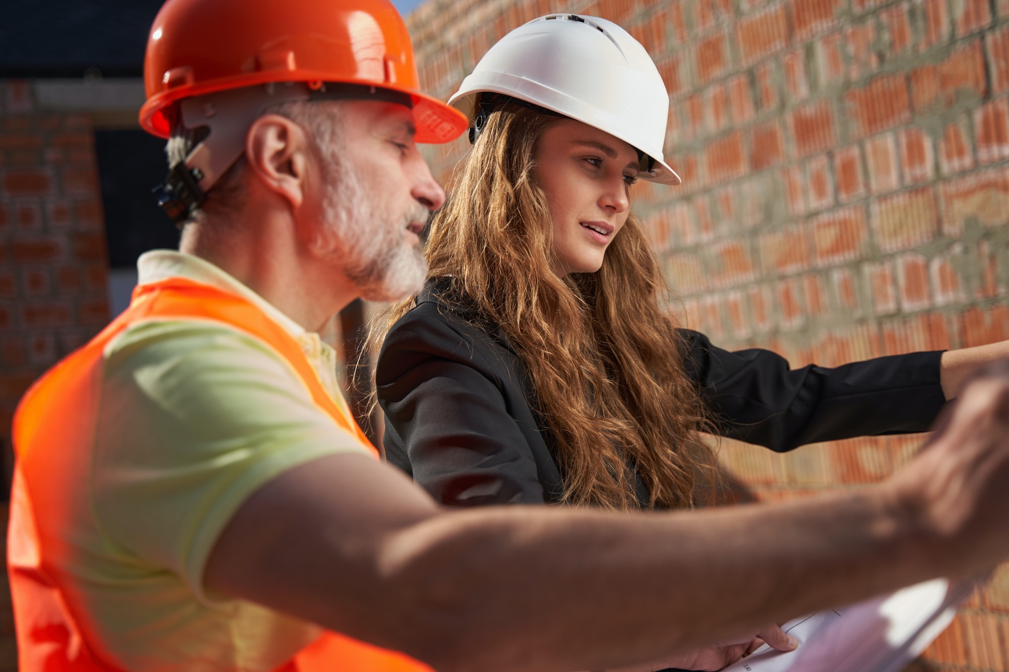 Concetrated construction site workers studying the building plans